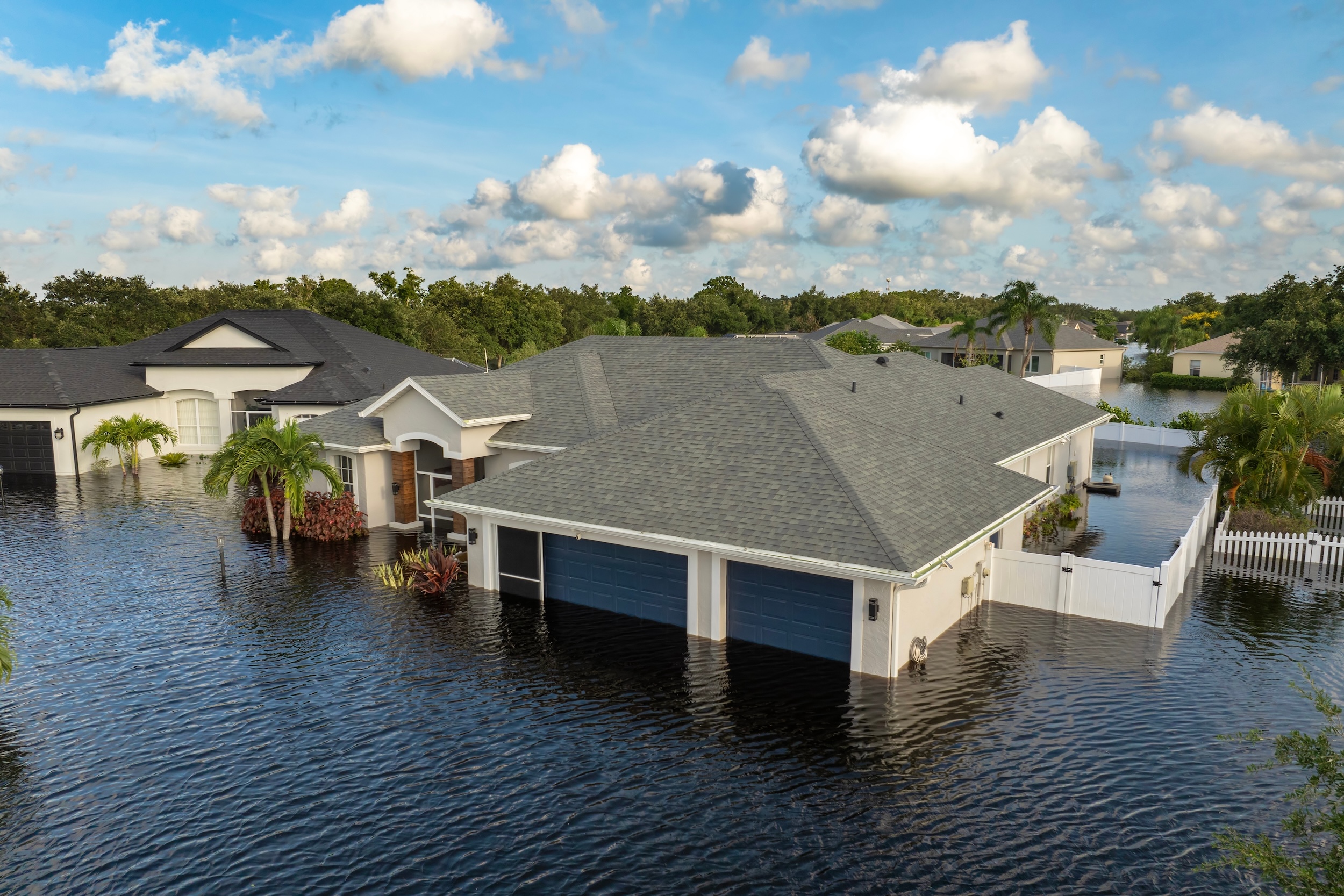Flooded houses from hurricane rainfall water in Florida residential community. Aftermath of natural disaster in USA south.